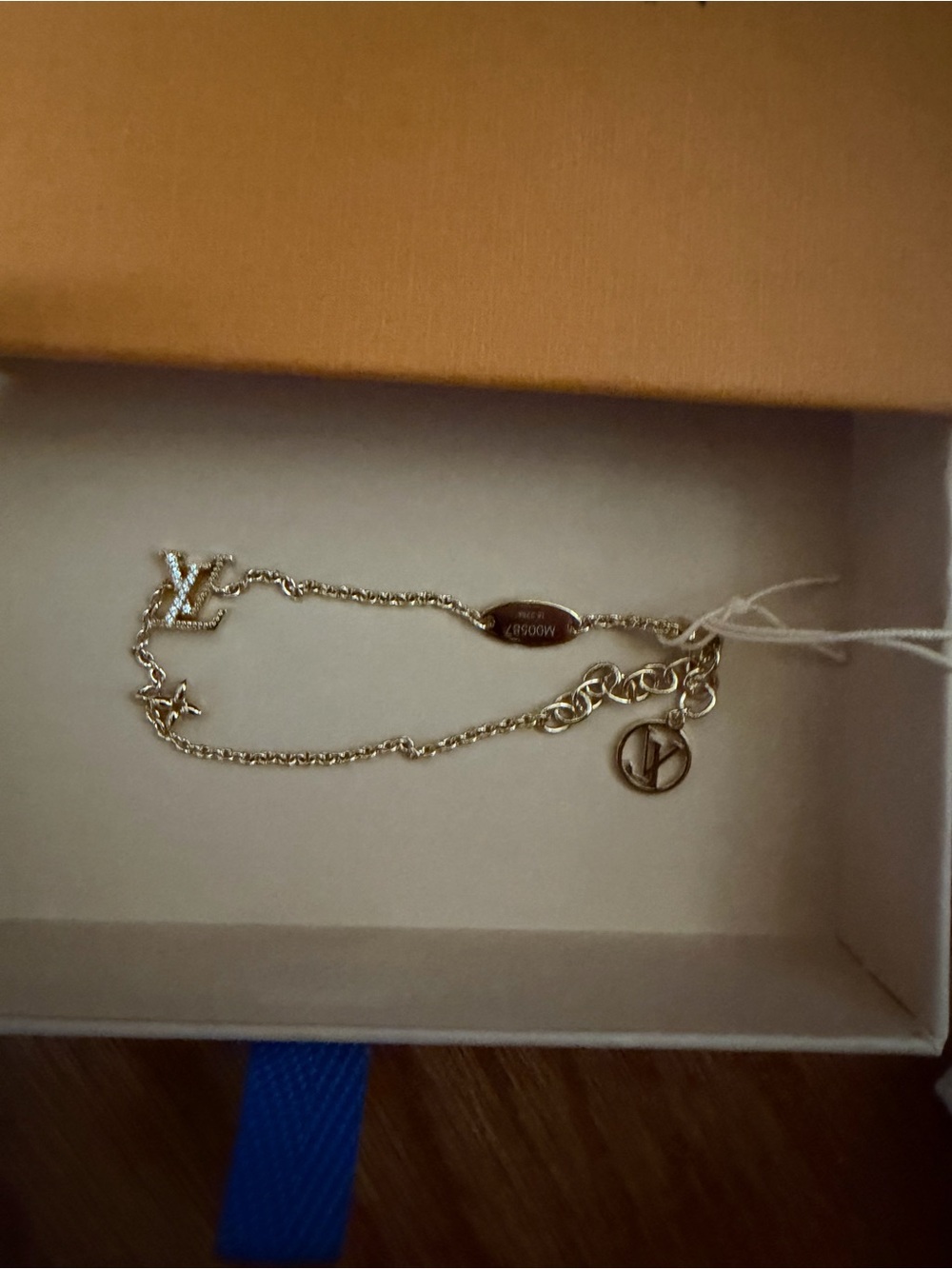 Louis Vuitton gold-tone double charm bracelet with LV logo